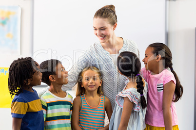 Teacher with schoolchildren in classroom