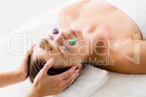 Woman receiving facial stone massage