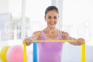 Portrait of happy woman with resistance band