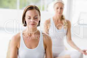 Women with eyes closed doing yoga