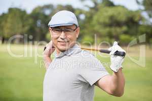 Side view of confident man holding golf club