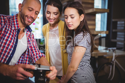 Coworkers smiling while looking at camera Coworkers smiling while looking at camera