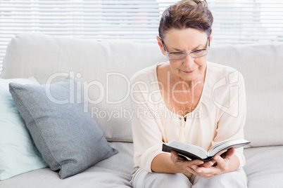 Mature woman reading book