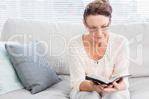 Mature woman reading book