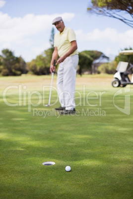 Full length of mature man playing golf