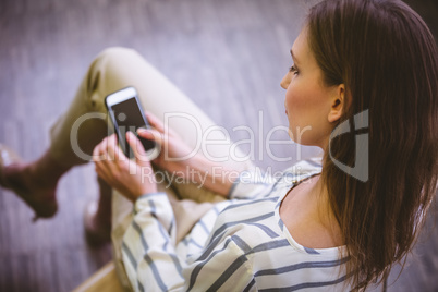 High angle view of businesswoman using mobile phone at office