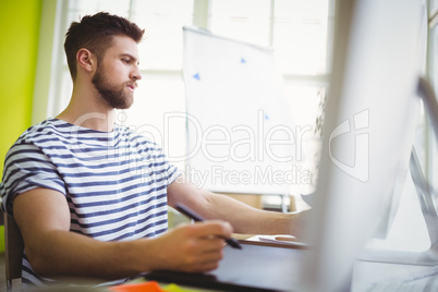 Businessman working at desk in creative office