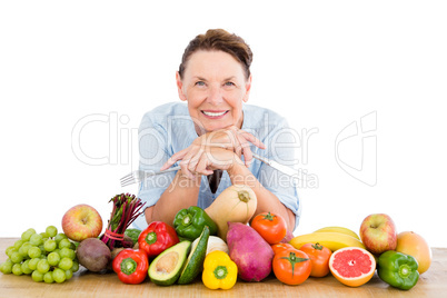 Portrait of smiling woman with fruits and vegetables at table