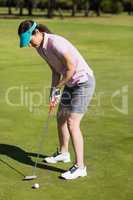 Full length side view of woman playing golf