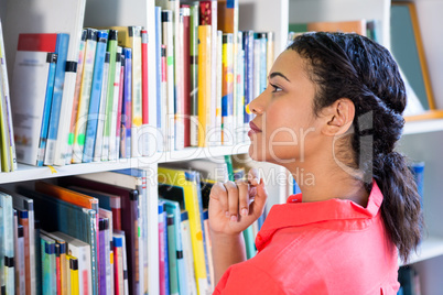 Teacher searching book in school library