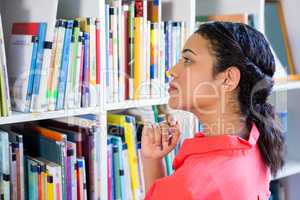 Teacher searching book in school library