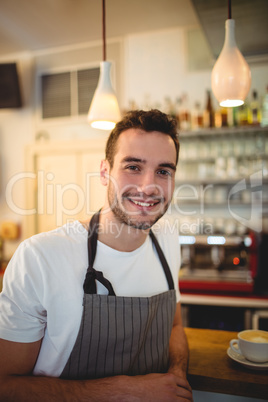 Portrait of confident barista at cafeteria