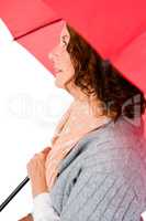 Thoughtful woman holding umbrella