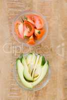 Tomato and avocado slices in bowl