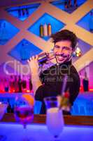 Handsome bartender preparing cocktail