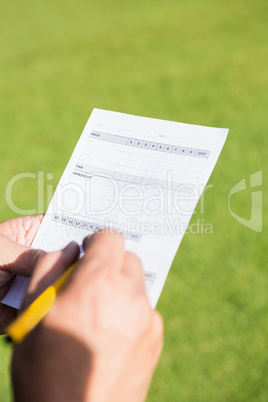 Close up of hand filling a piece of paper