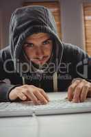 Portrait of young man using computer keyboard