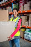 Smiling worker holding boxes