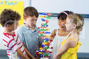 Schoolchildren holding DNA model