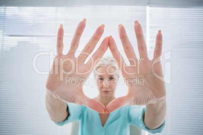 Senior woman with hands on glass