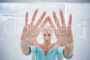 Senior woman with hands on glass