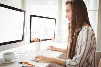 Businesswoman working on computer in office