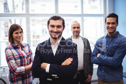 Smiling business people with arms crossed