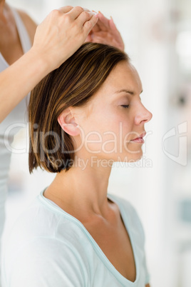 Cropped image of masseur giving massage to woman