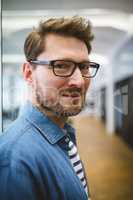 Smiling businessman in creative office