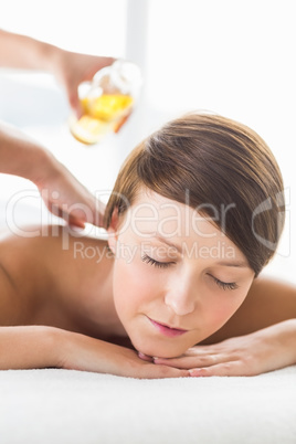 Woman receiving oil massage