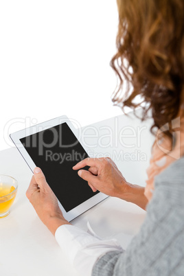 Cropped image of woman using tablet