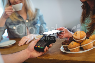 Customer paying through technology at cafe