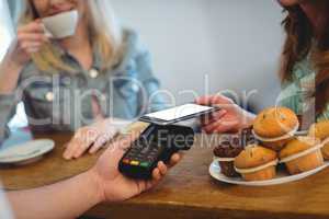 Customer paying through technology at cafe