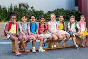 Smiling schoolchildren on seat