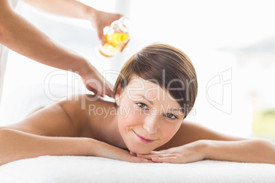 Portrait of woman receiving oil massage treatment