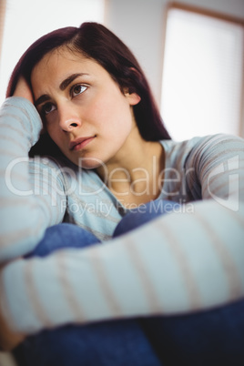 Depressed young woman at home