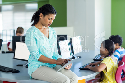 Female teacher using digital tablet