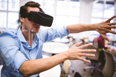 Executive gesturing while using virtual reality glasses at offic
