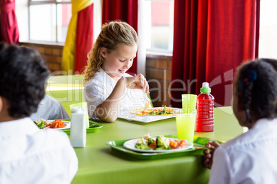 Schoolgirl having food with classmates