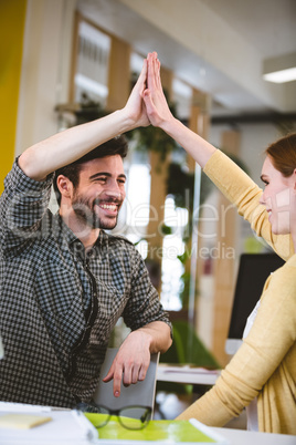 Colleagues giving high-five