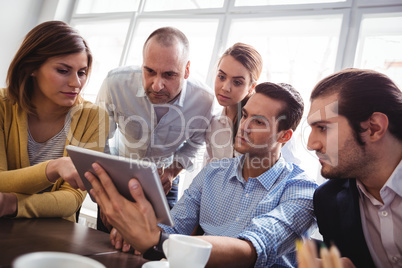 Business people using digital tablet in office