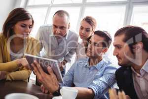 Business people using digital tablet in office