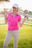 Woman golfer posing with her golf club