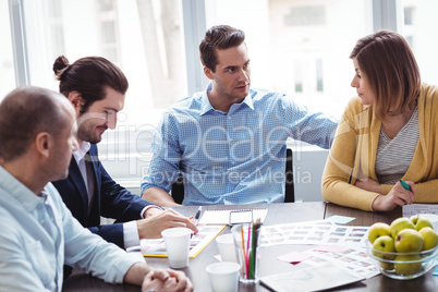 Photo editors discussing in meeting room