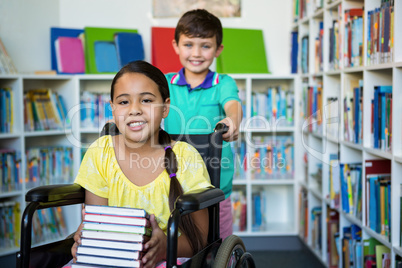Portrait of handicapped girl with boy at library