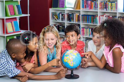 Children with globe on table