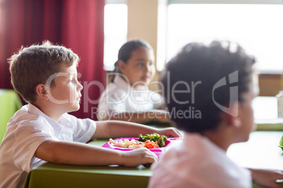 Boy with classmates in canteen