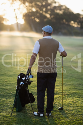 Rear view of man standing at golf course
