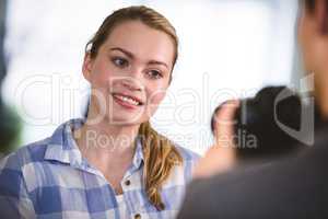 Colleague posing for photographer at creative office