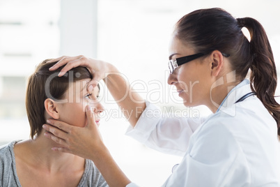Doctor checking woman eye